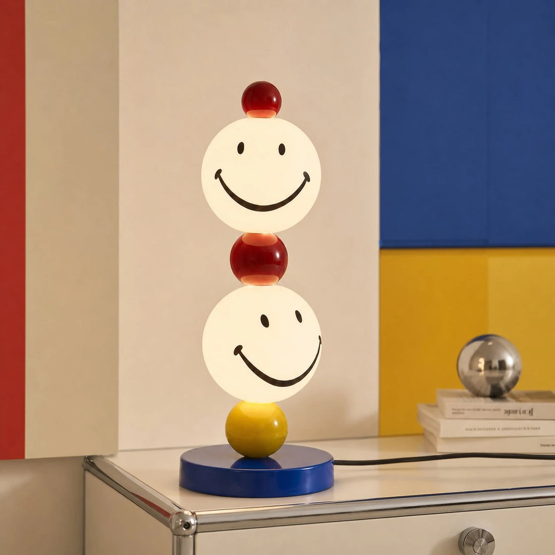 Smiley stack table lamp on a graphic console