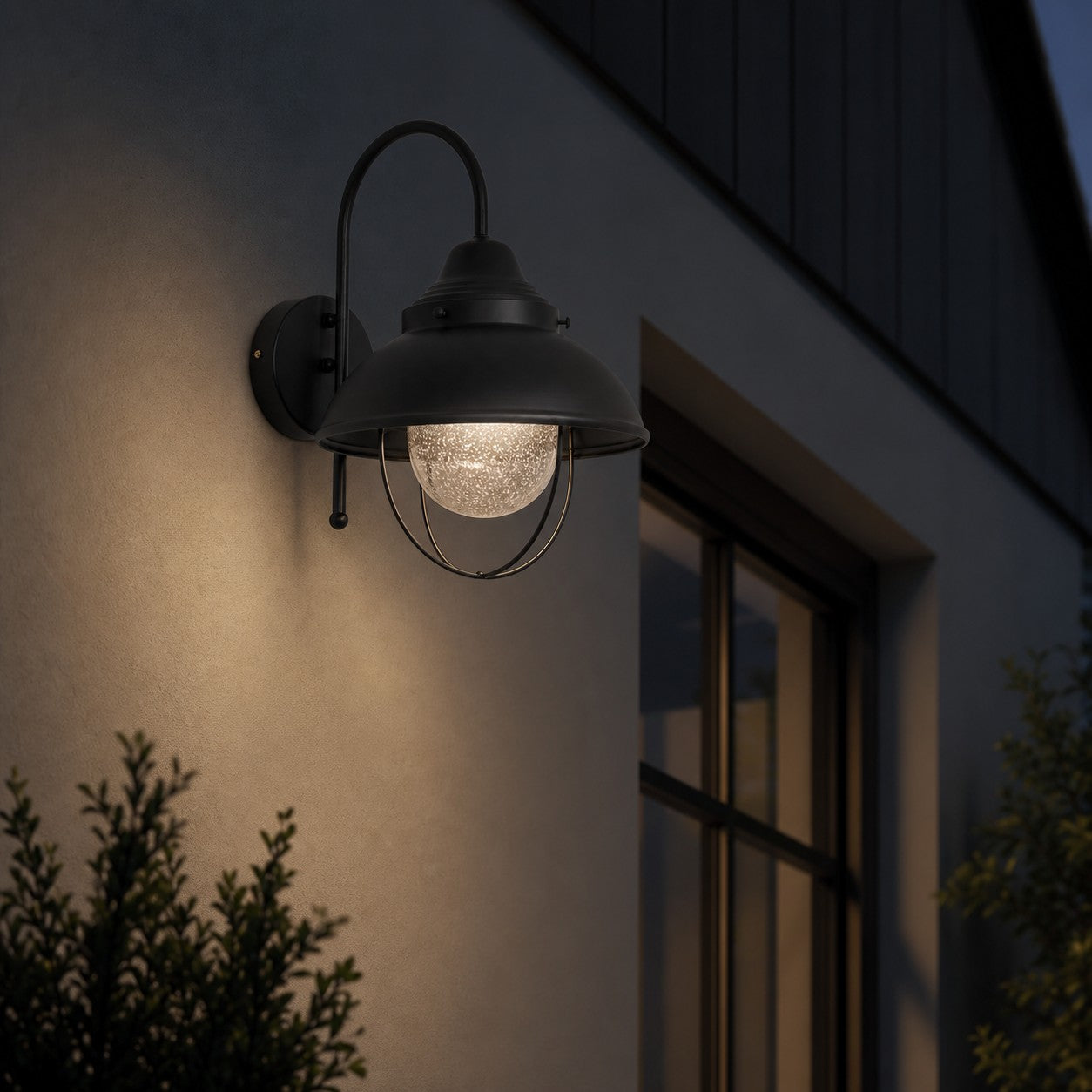 Black seeded-glass wall lamp creating a warm evening accent