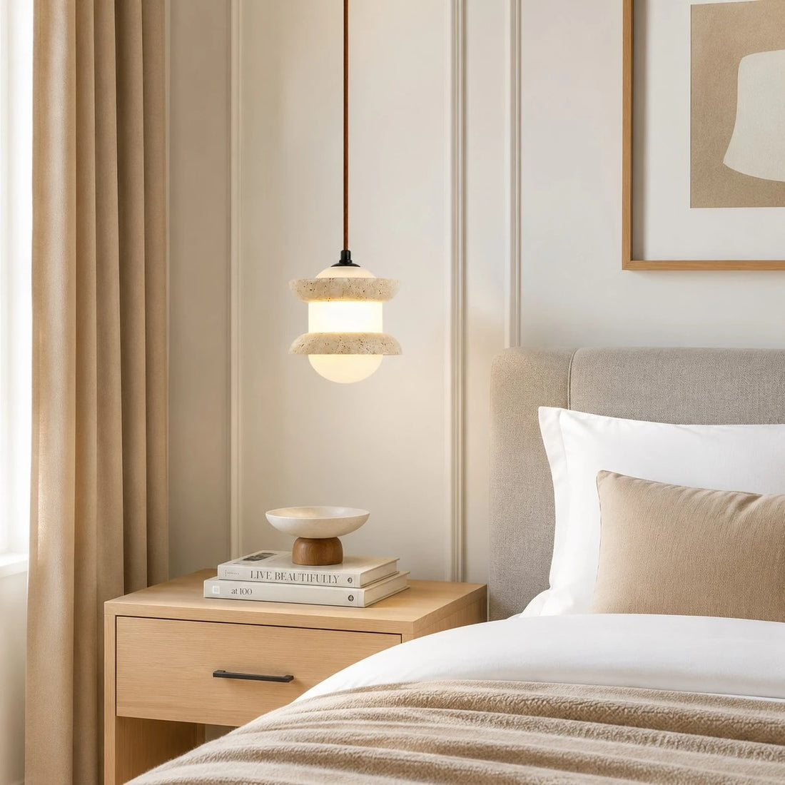 Single travertine stone pendant light beside a bed