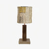 Yellow patch shade loofah table lamp on a white background