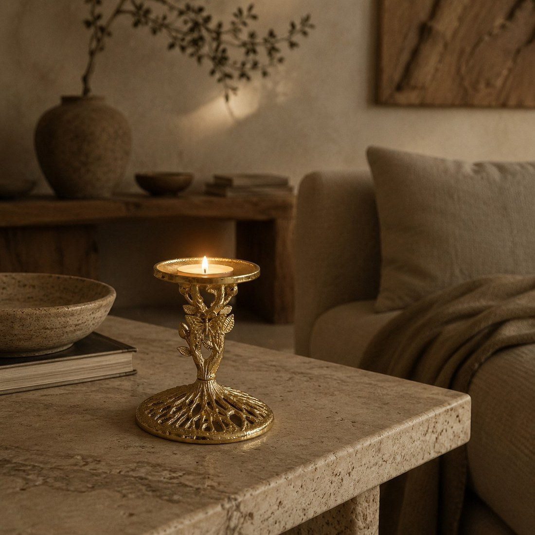 Aura candlestick on a stone coffee table with warm candlelight