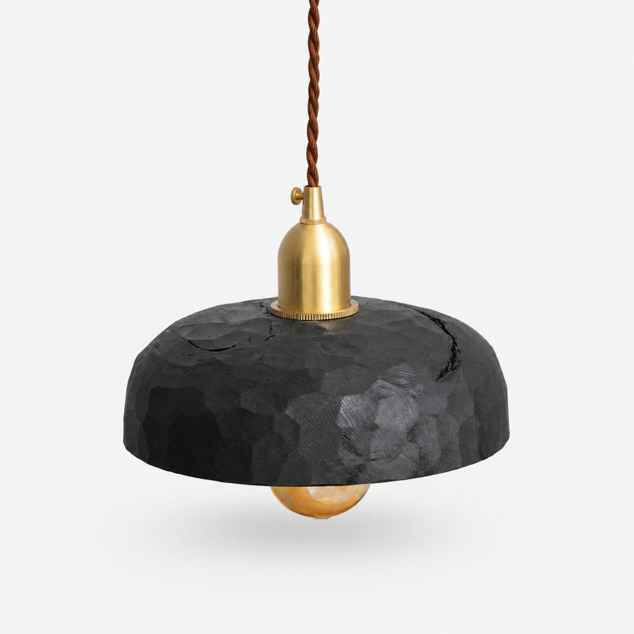 Black carved wood pendant lamp on a clean background