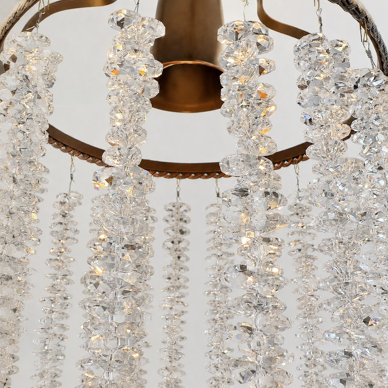 Close view of clear crystal fringe suspended from the metal frame