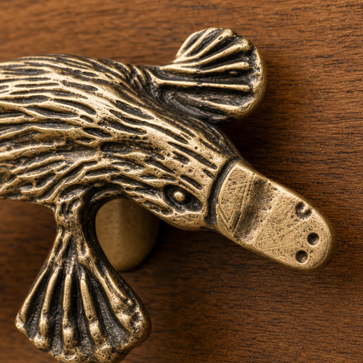 Close macro of Totem platypus handle head and carved copper texture
