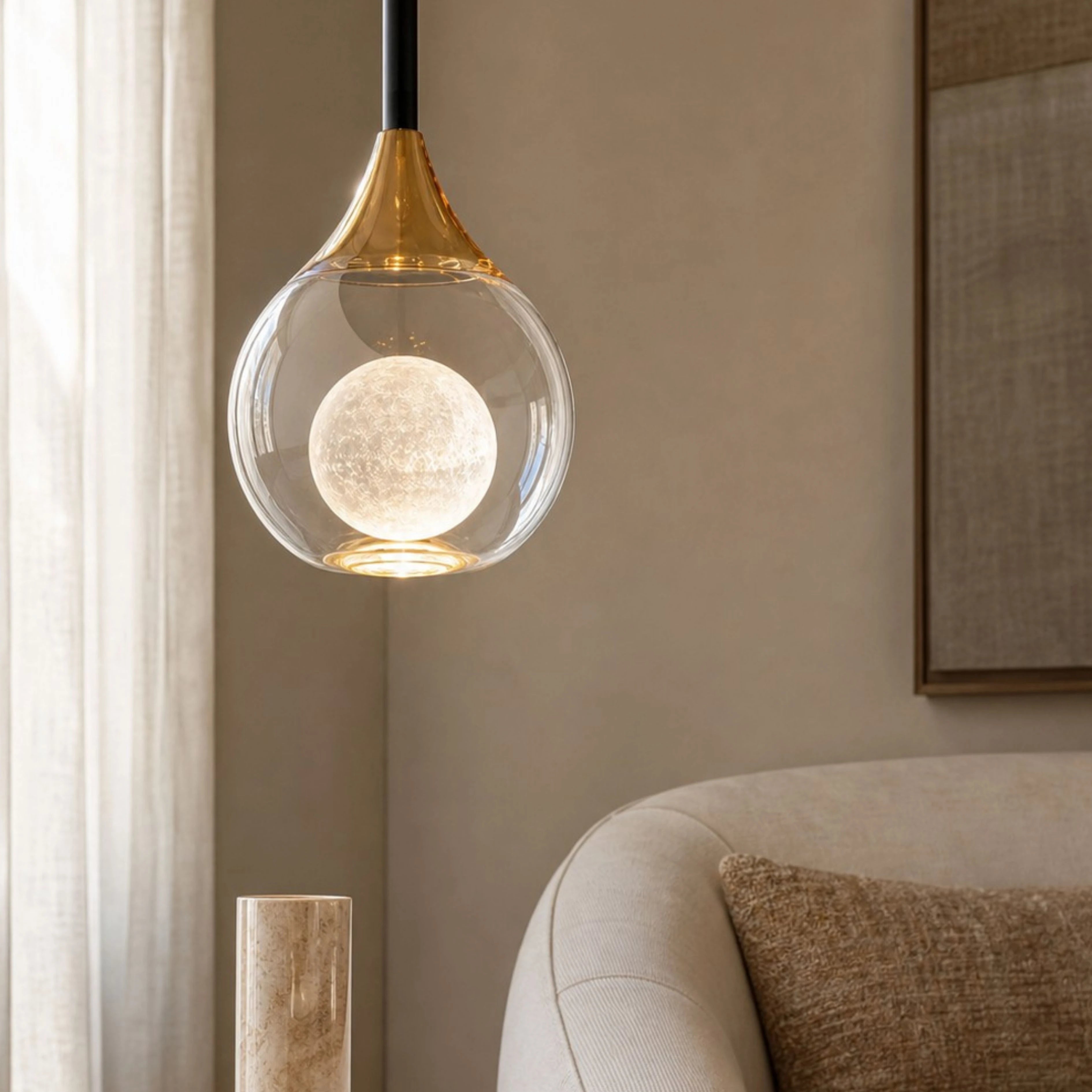 Gold Luma pendant illuminated in a warm interior