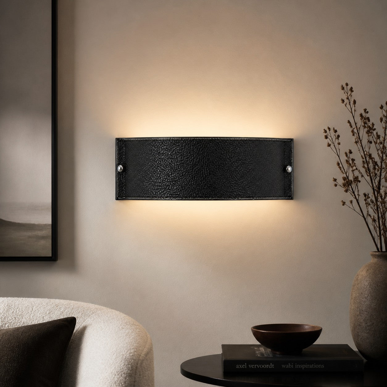 Black leather wall lamp in a dark neutral living room