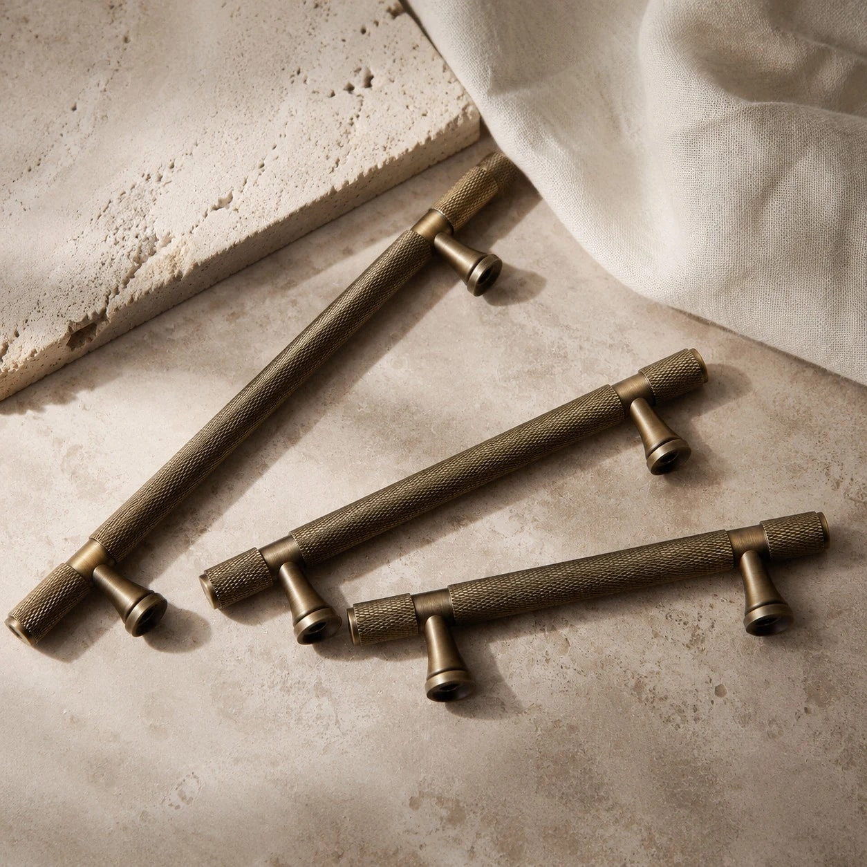 Antique brass cabinet pulls grouped on stone surface