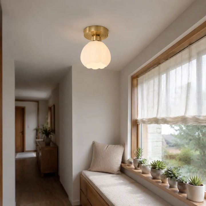 Milk glass flower ceiling light above a window seat