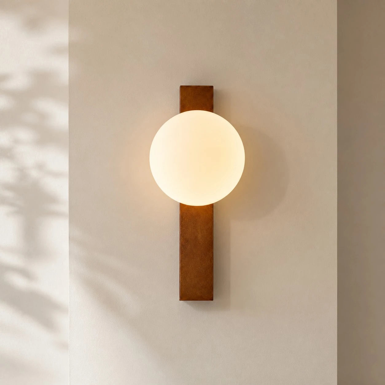 Vertical Walnut globe wall sconce on a minimal wall