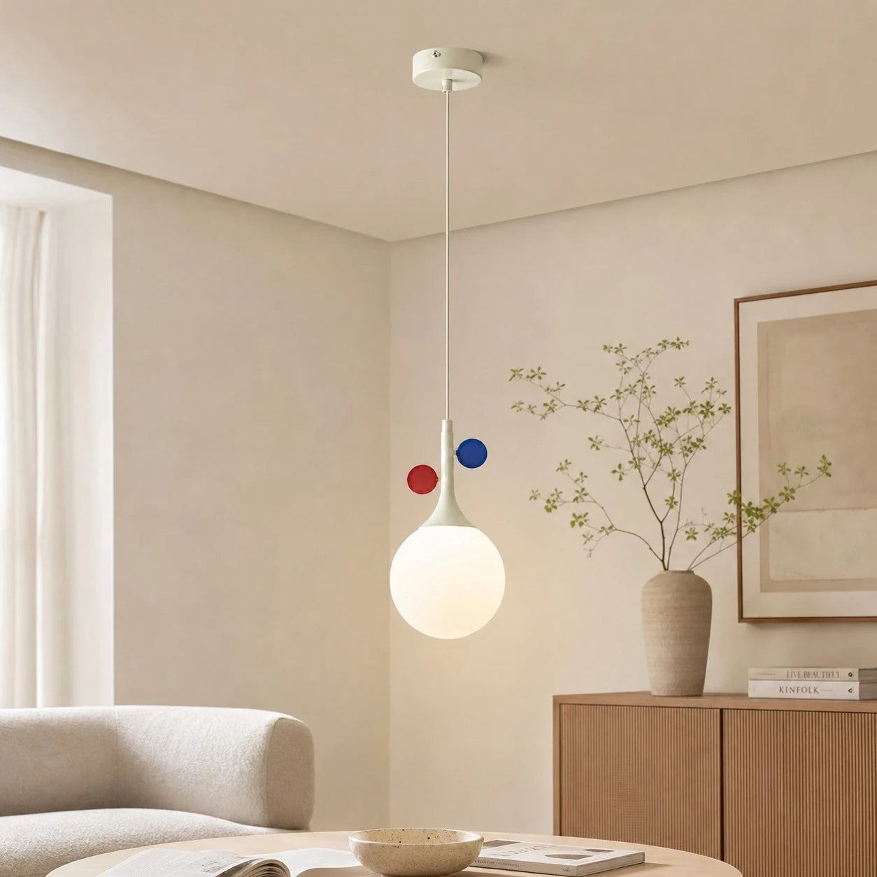 Cream orbit-disc pendant in a bright living room
