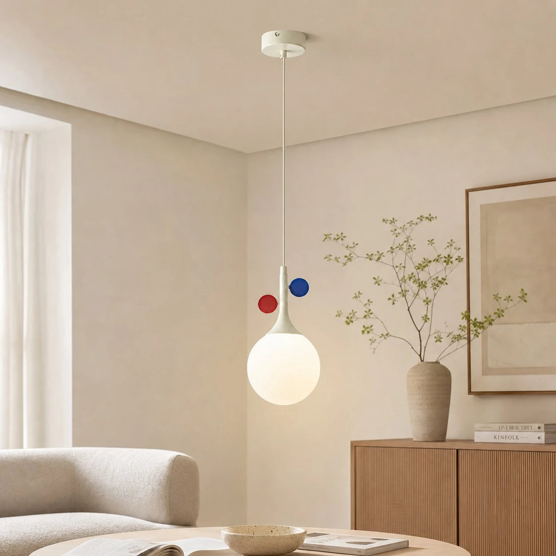 Cream orbit-disc pendant in a bright living room