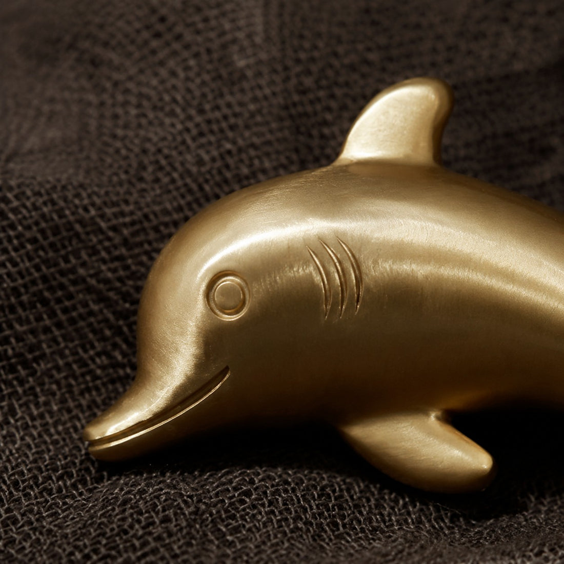 Detailed dolphin face and gill grooves on the Totem handle