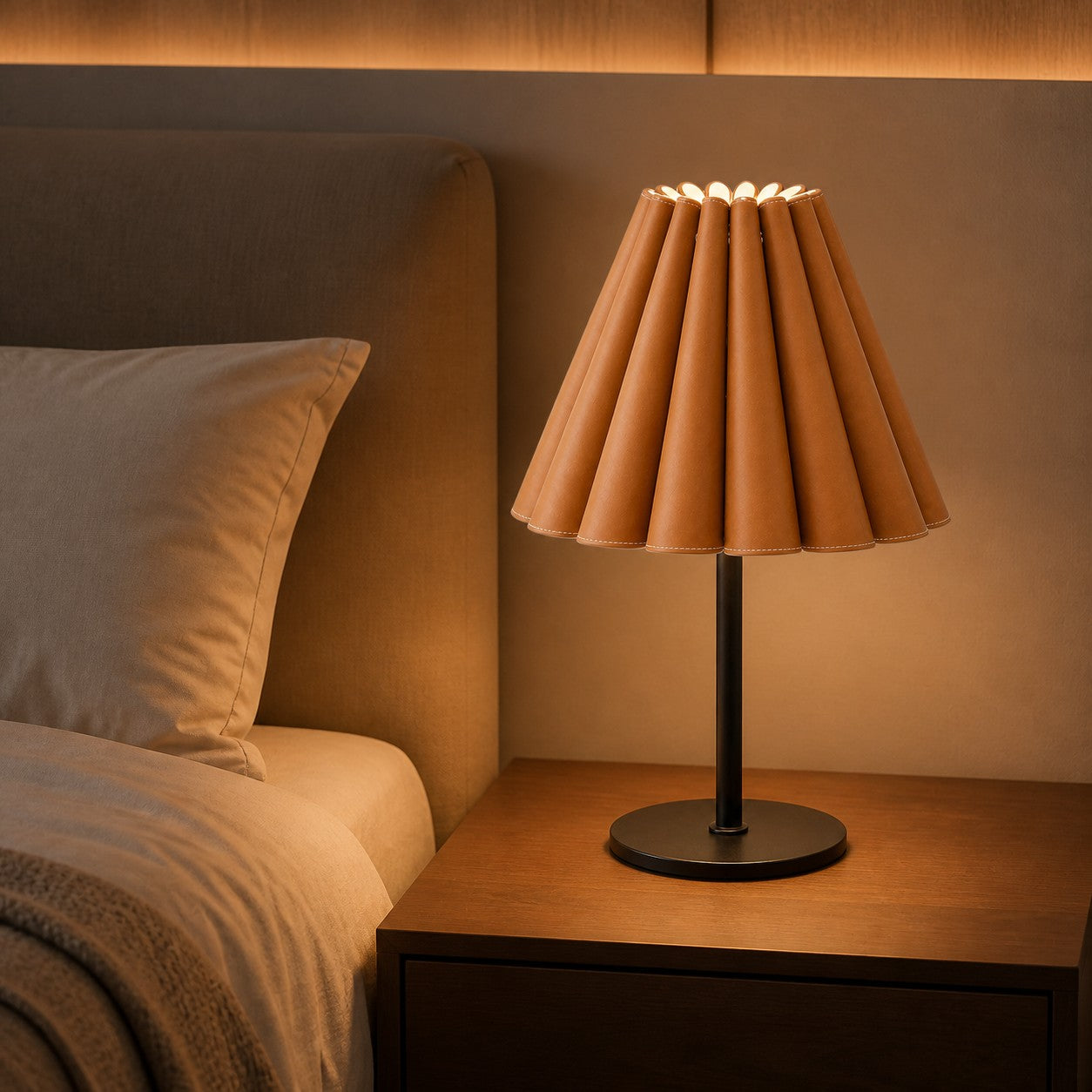 Caramel brown pleated leather table lamp beside a bed