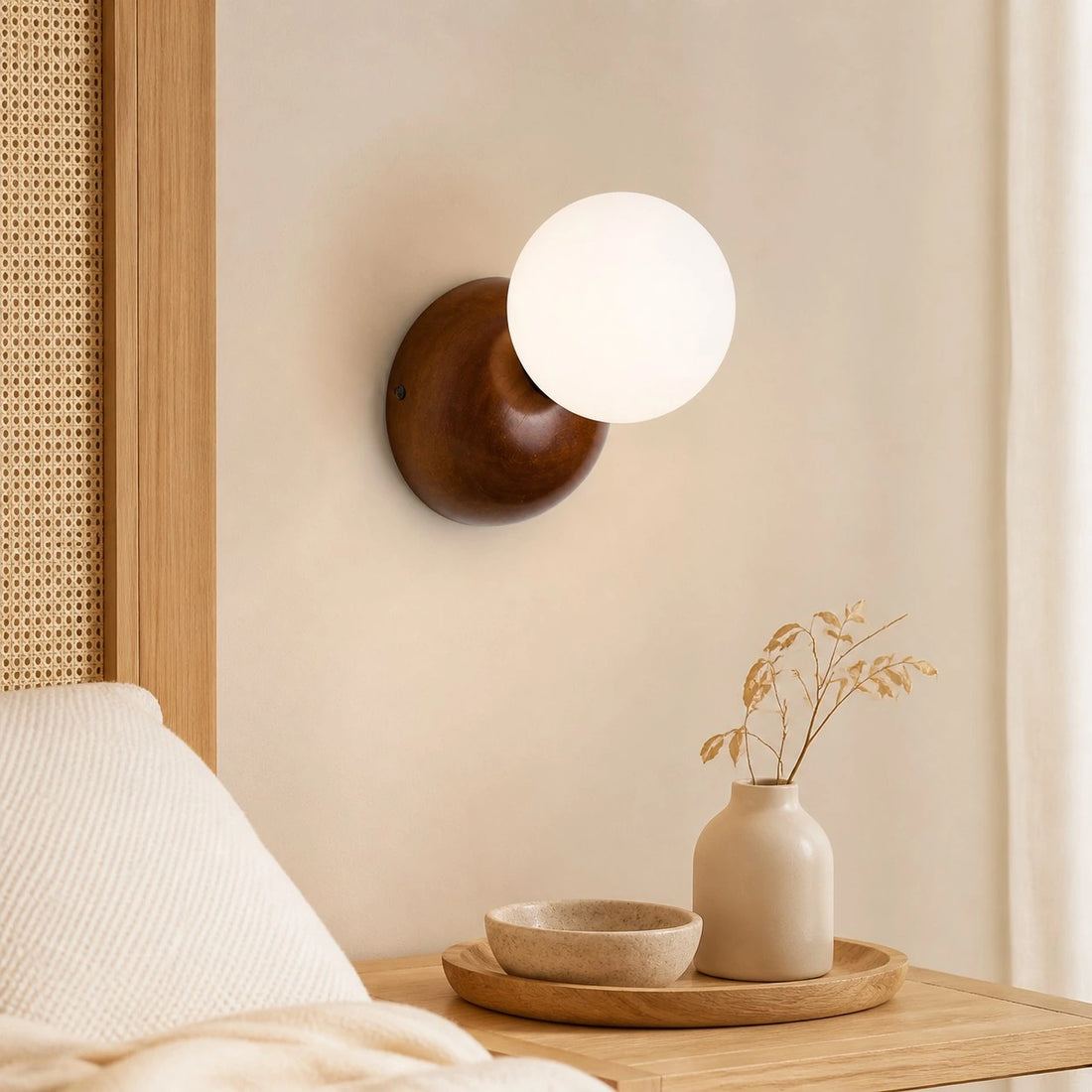 Luma walnut wall sconce above a bedside table