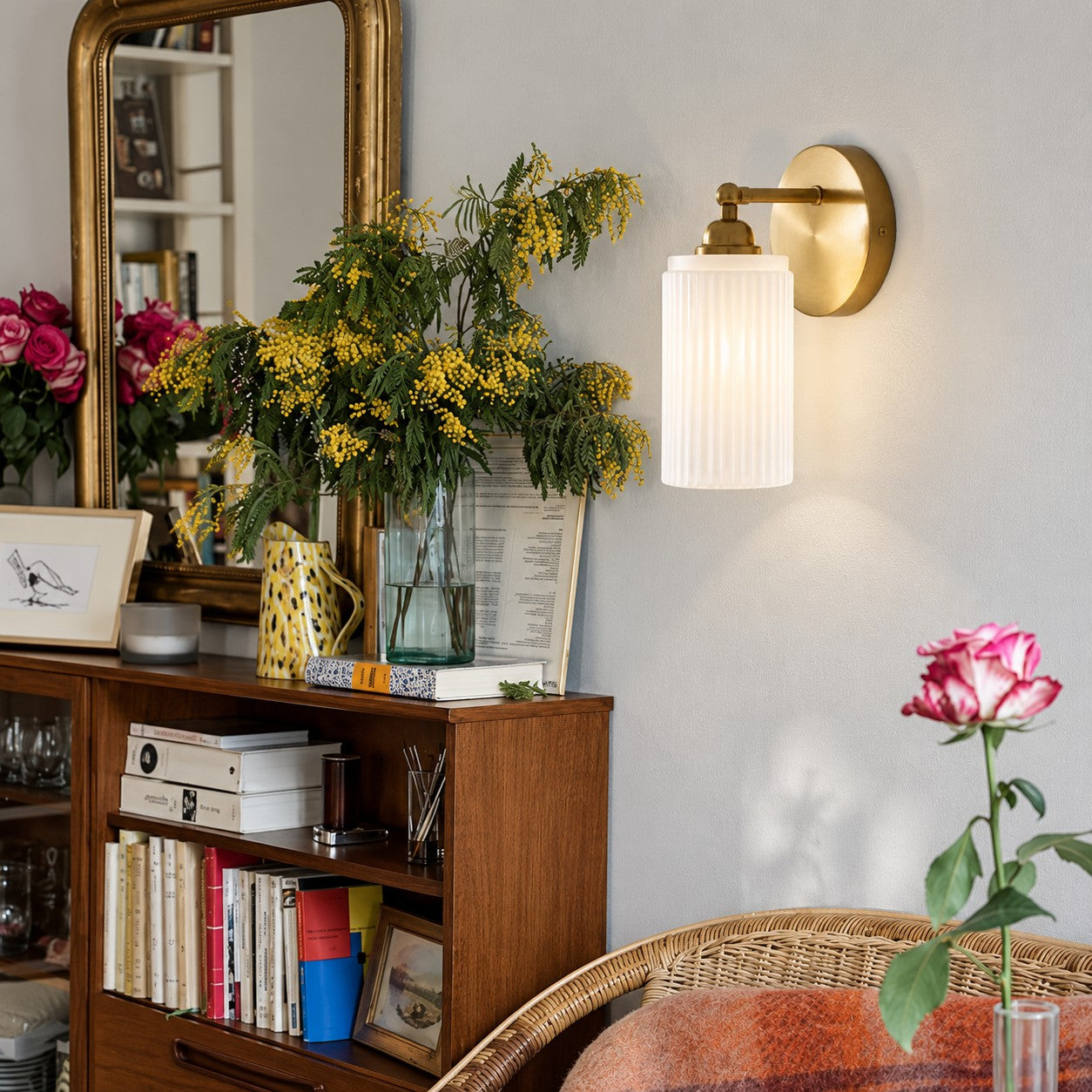 Aura vintage ribbed glass wall sconce beside a living room bookshelf