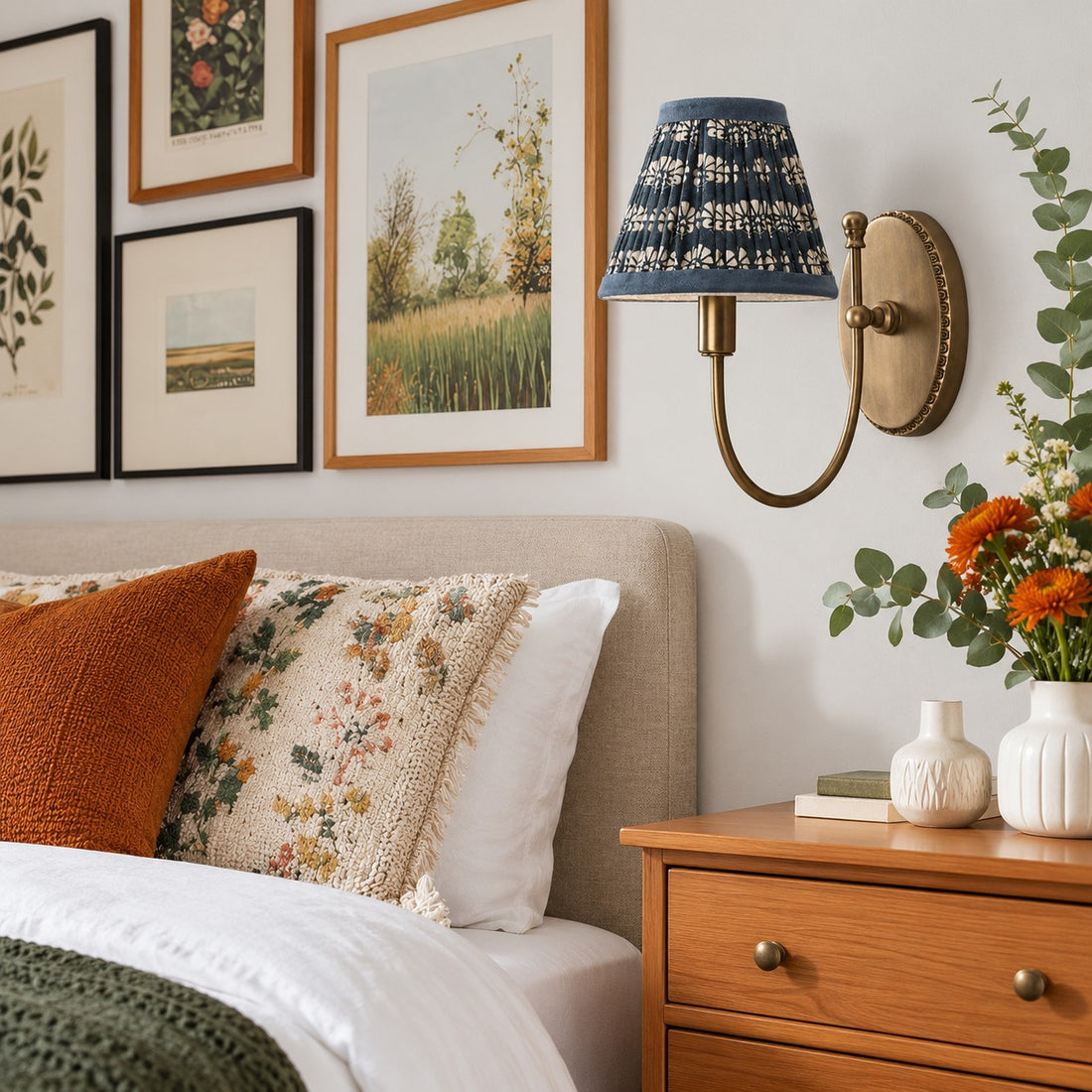 Avelora blue floral wall sconce styled above a bedroom nightstand