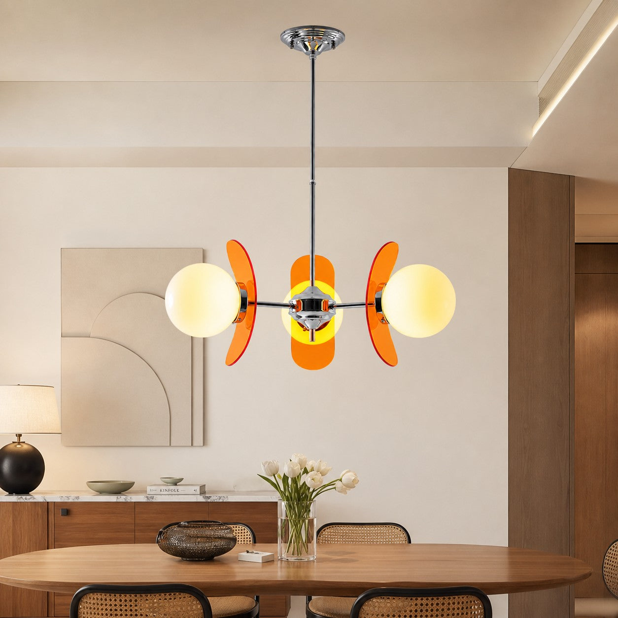 Three-head Orange Luma chandelier in a dining room