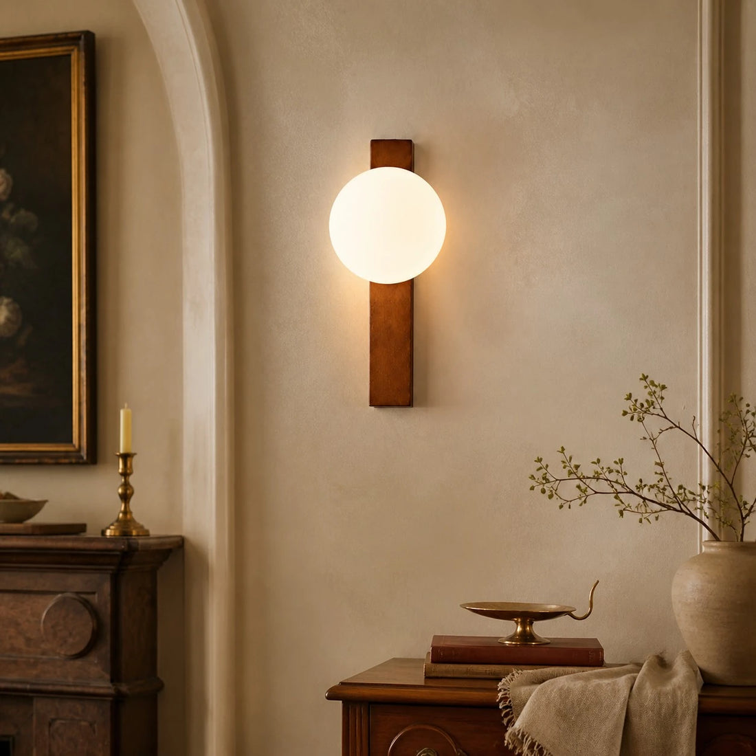 Vertical Walnut globe wall sconce in a classic interior