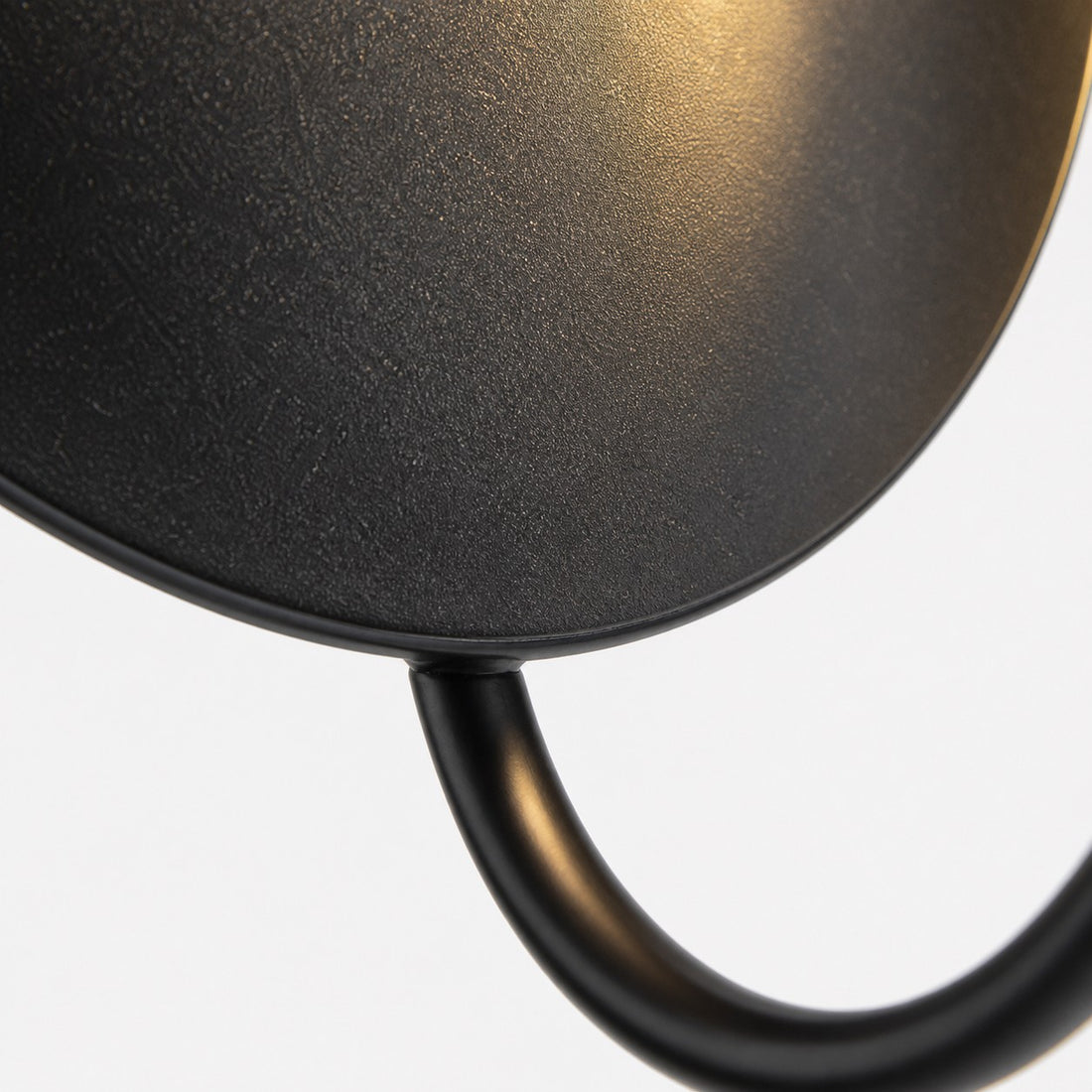 Curved stem and textured metal disc detail