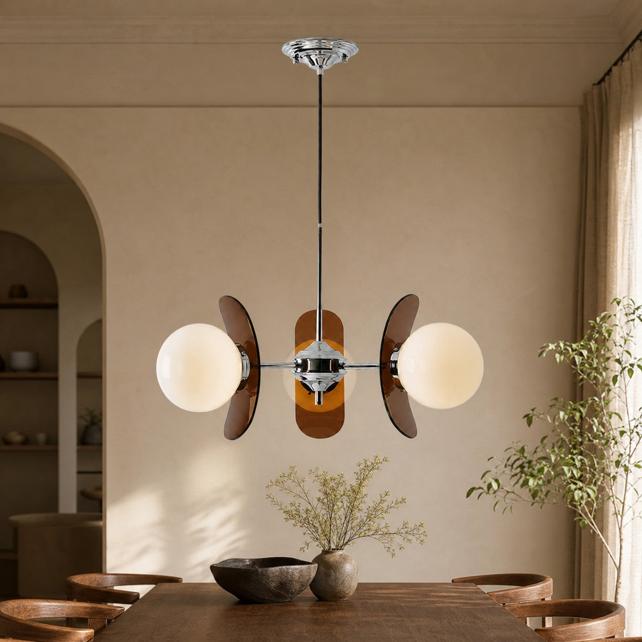 Three-head Amber Luma chandelier above a dining table