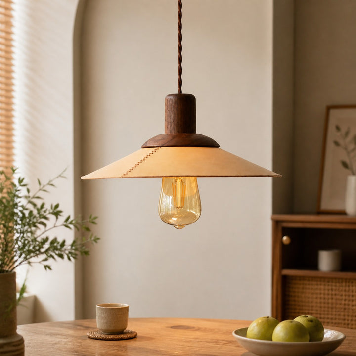 Natural leather and walnut pendant above a dining table