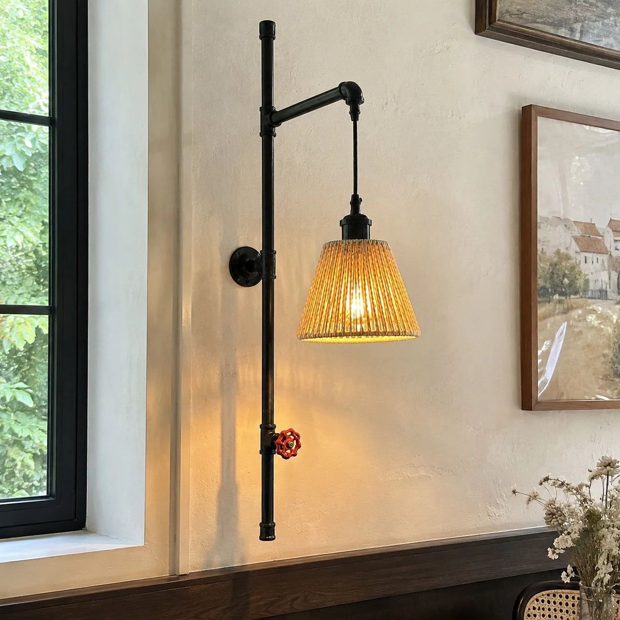 Pipe wall sconce beside framed wall decor