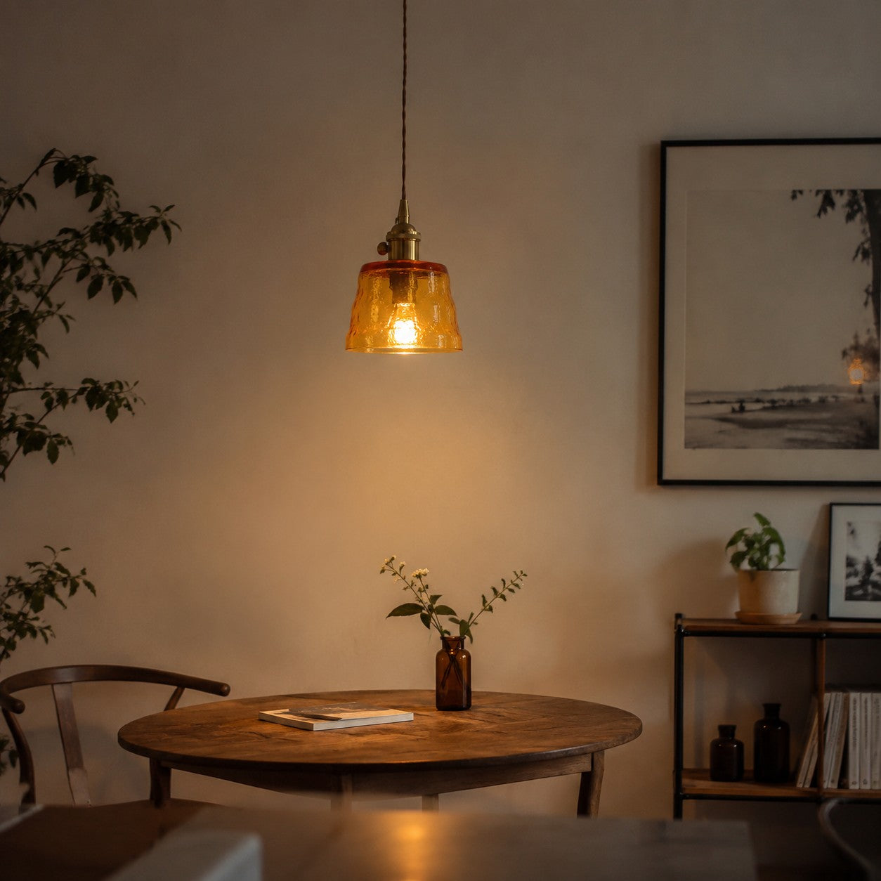 Amber glass pendant light above a dining table