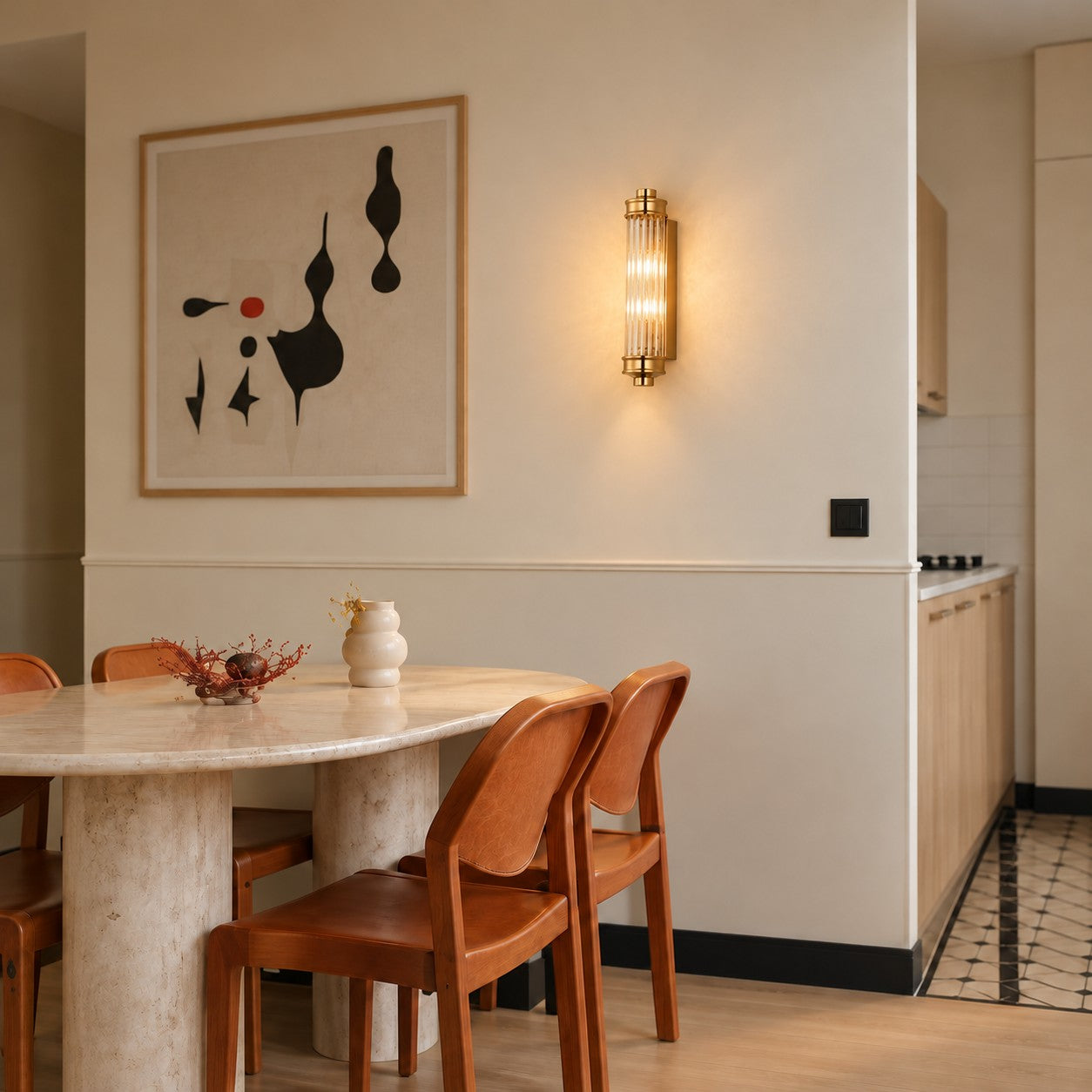 Ribbed cylindrical wall sconce styled above a travertine table
