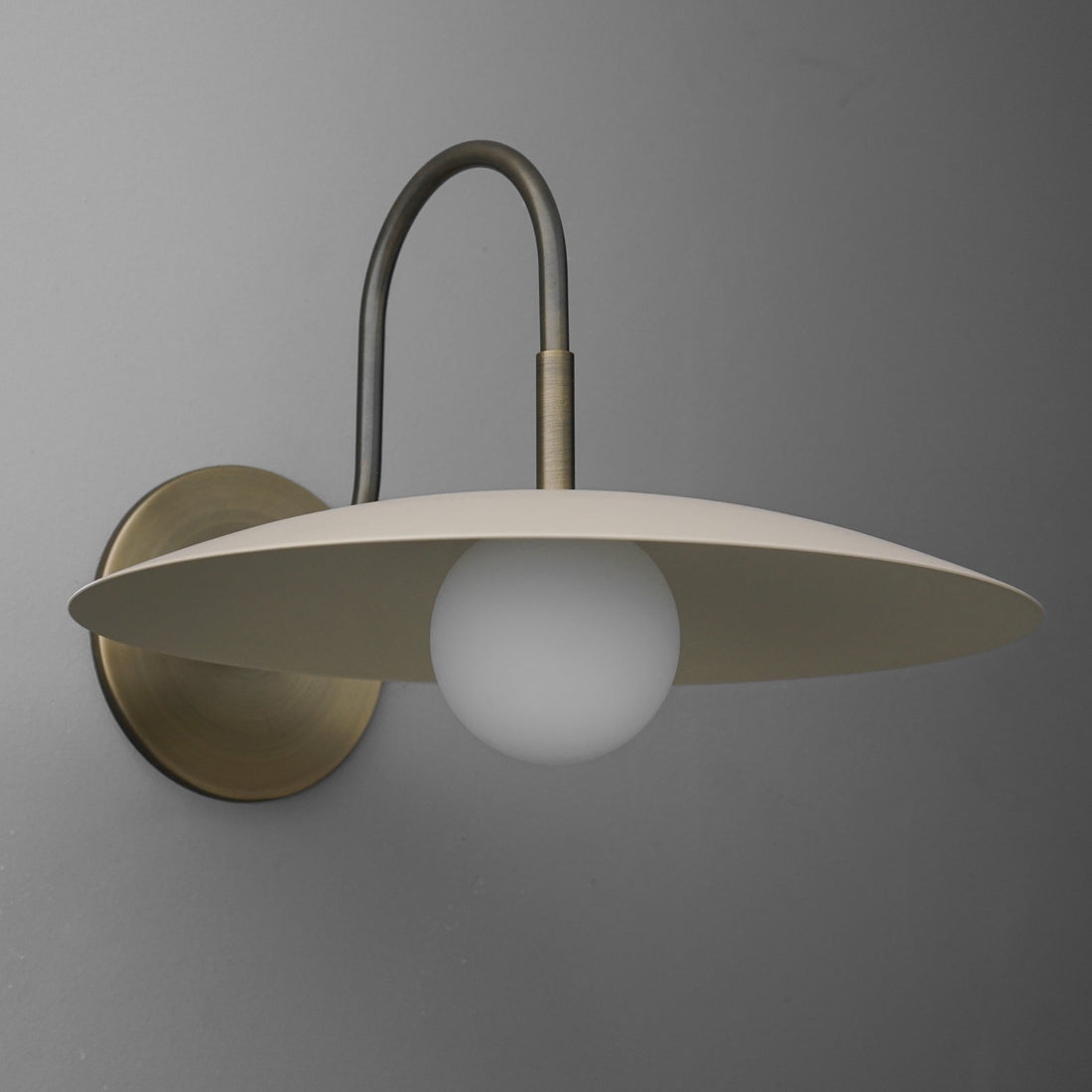Curva Metal Modern Wall Sconce - Antique Brass Arm with Cream Disc Shade