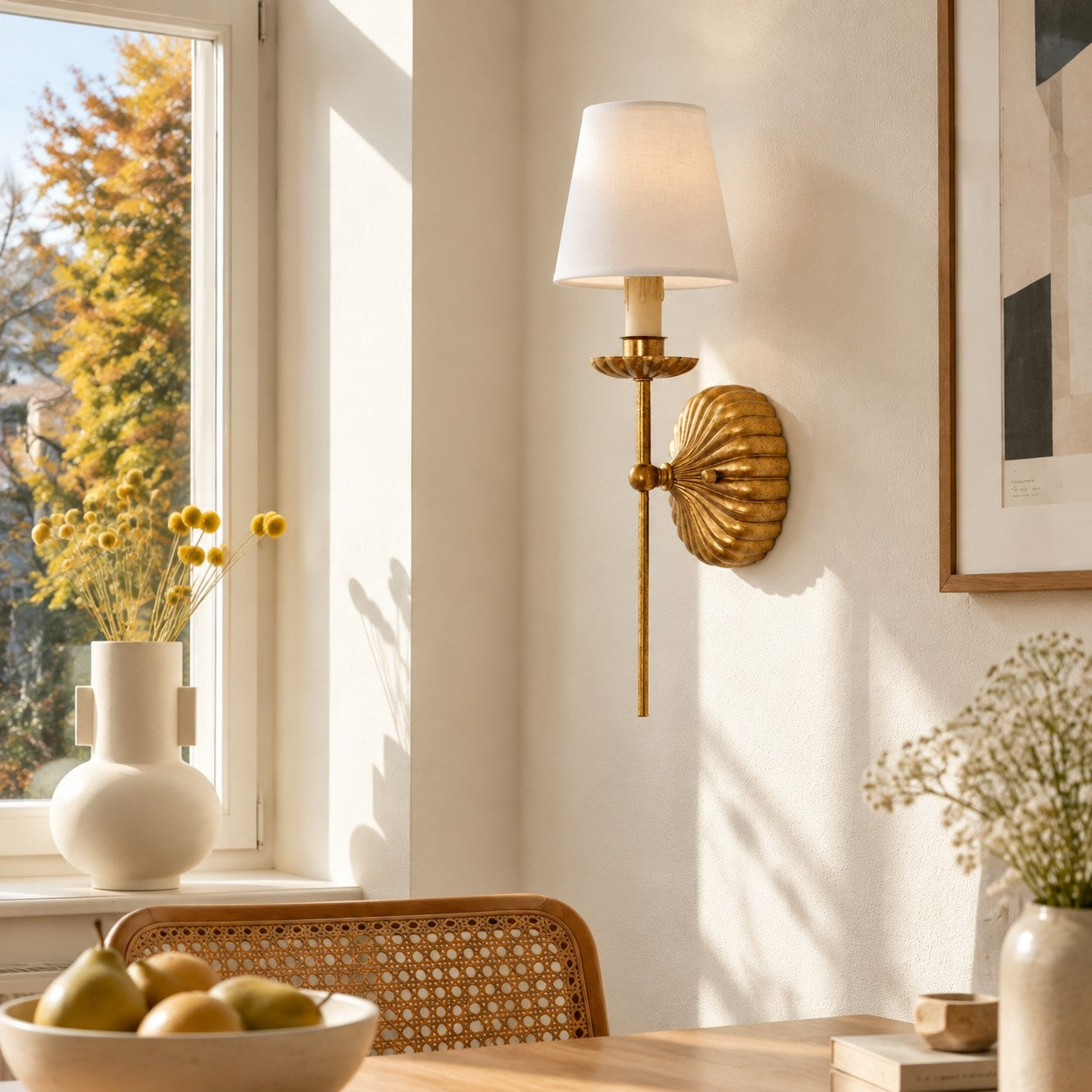 Catina single sconce styled by a sunlit dining window