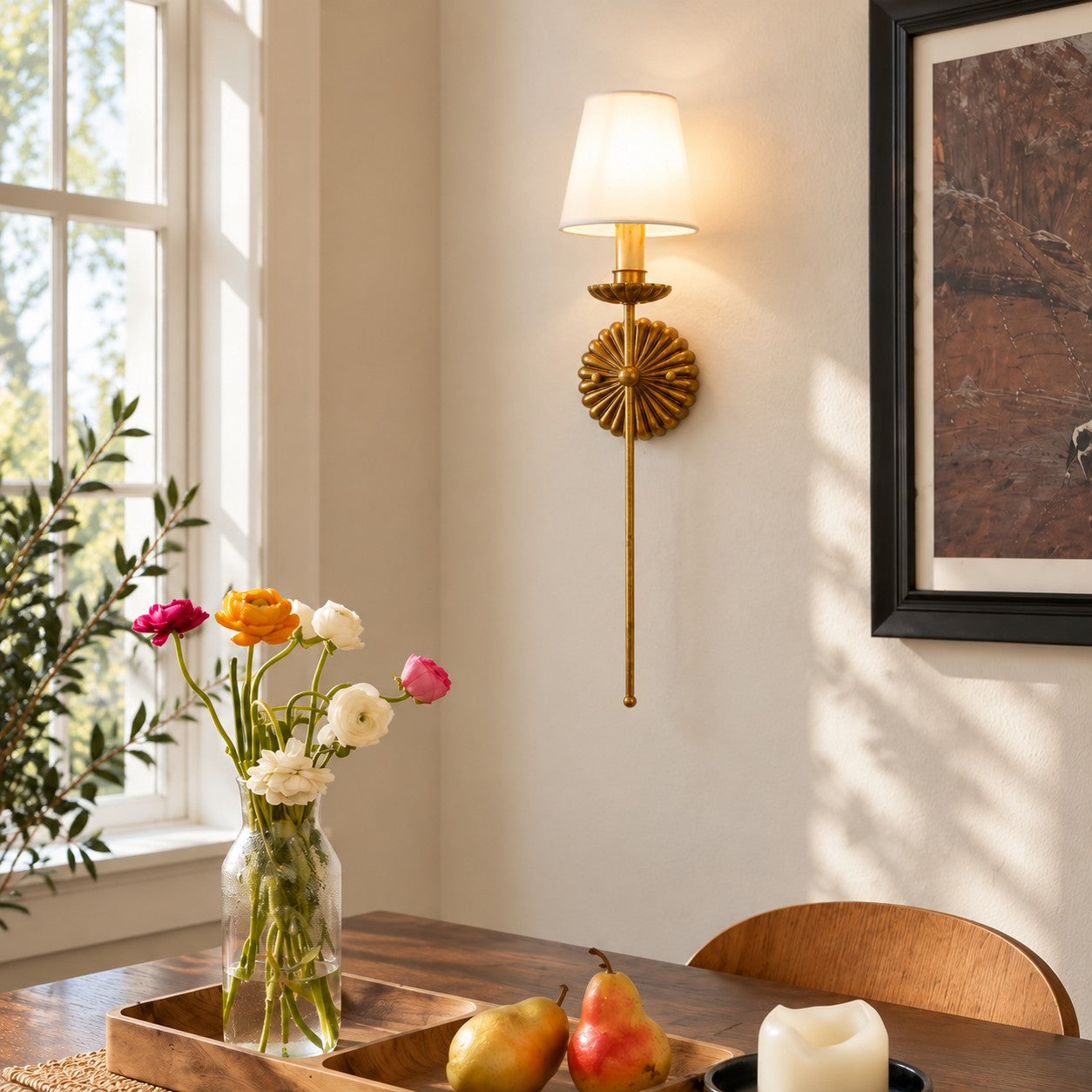 Catina single sconce styled above a dining table with flowers