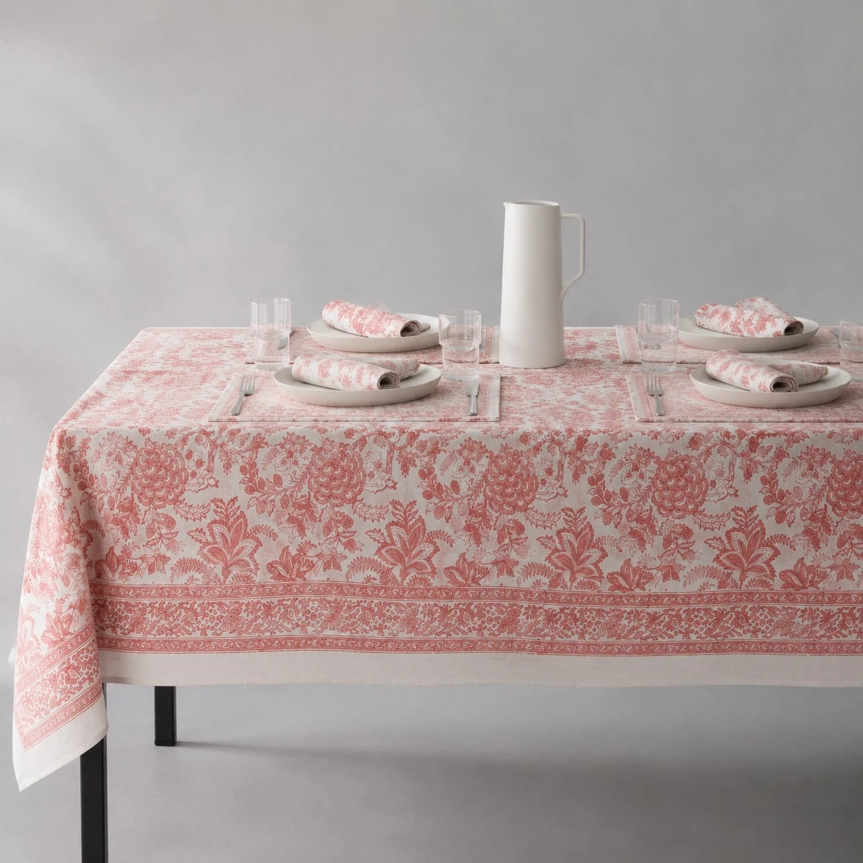 Soft coral floral tablecloth on a dining table