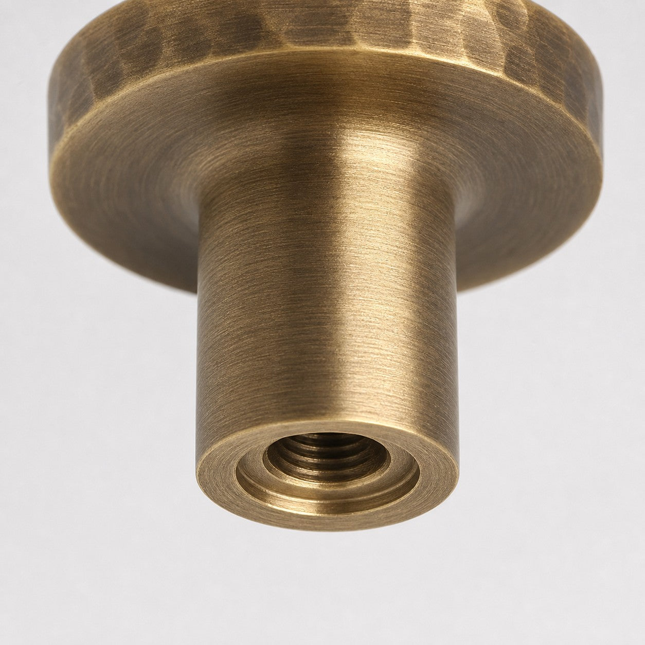 Close view of threaded mounting hole on antique brass knob