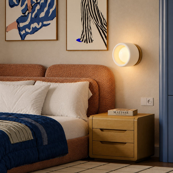 Cerova style A sconce styled beside a boucle headboard