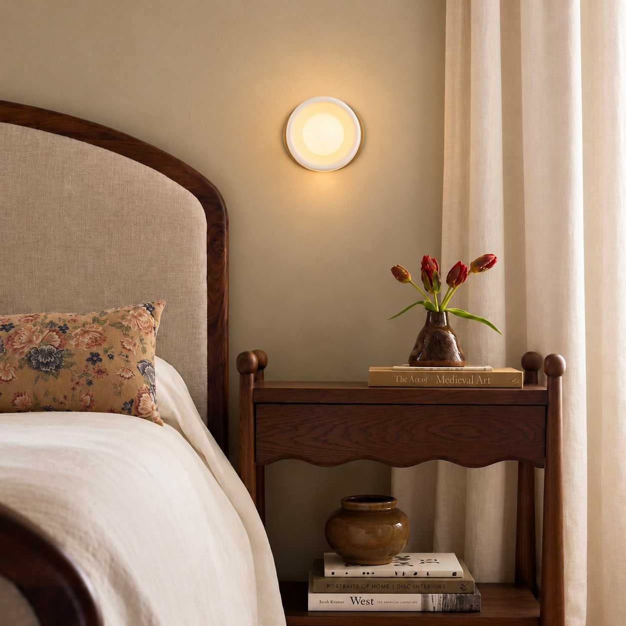Cerova style A sconce styled beside a wood headboard
