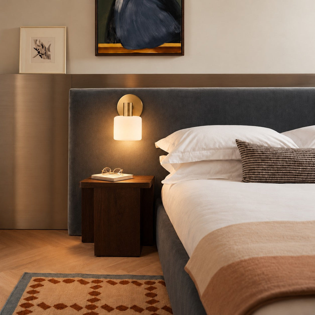 Cerova style B sconce styled beside a navy headboard