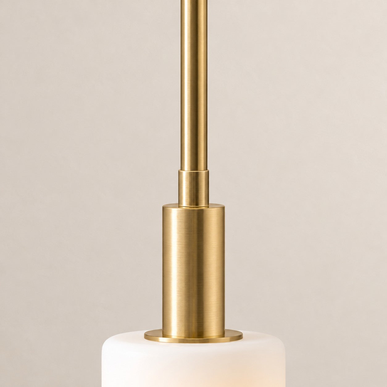 Brass stem meeting the white porcelain shade