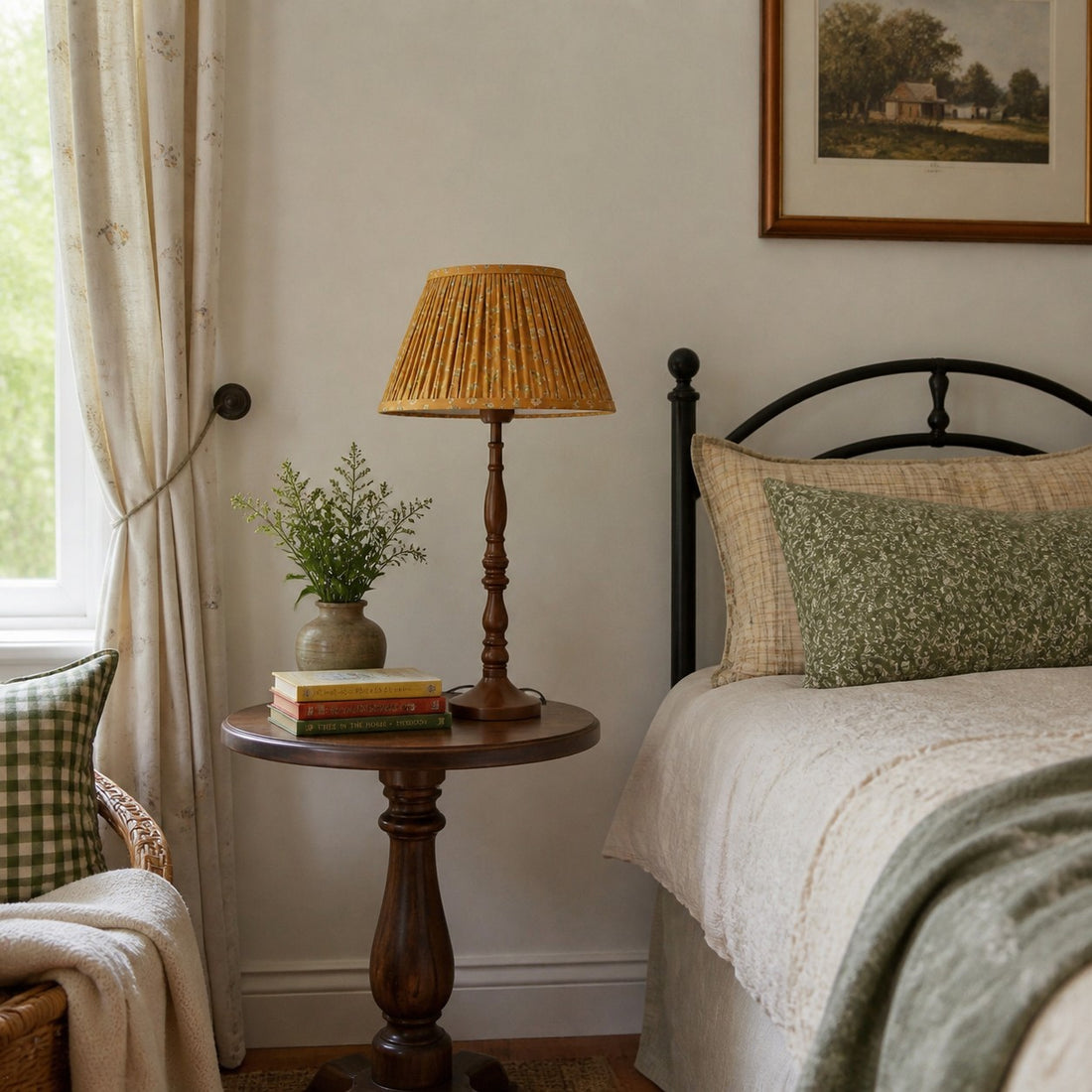 Floral pleated shade table lamp beside a bed