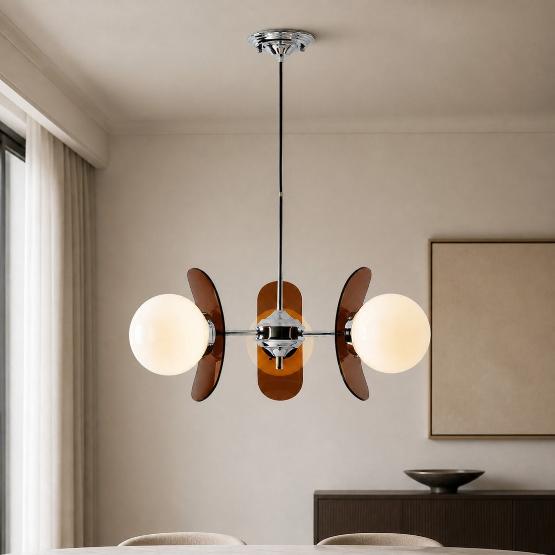 Three-head Amber Luma chandelier in a neutral interior