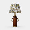 Deep brown vintage table lamp with yellow floral pleated shade on white background