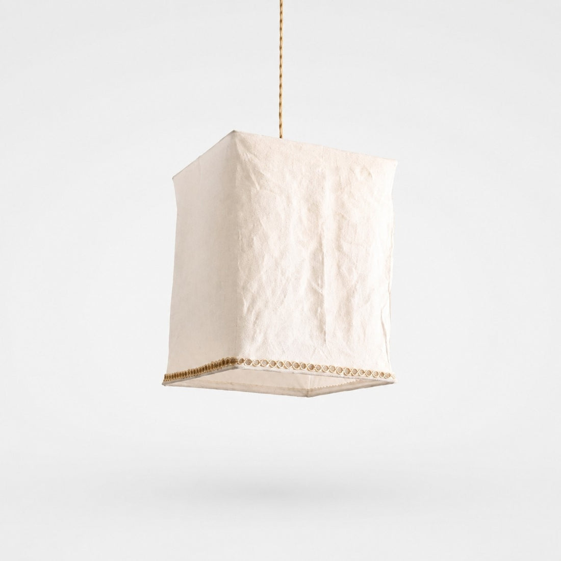 Sculptural linen pendant light on a clean light background