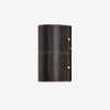 Dark brown leather wrapped wall sconce on clean background