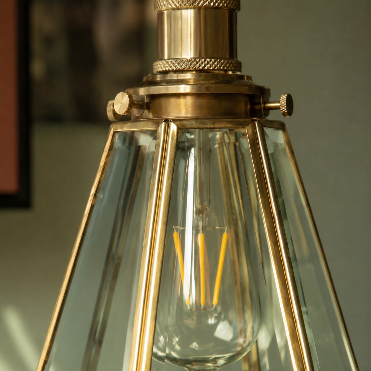 Close view of clear glass shade and brass frame