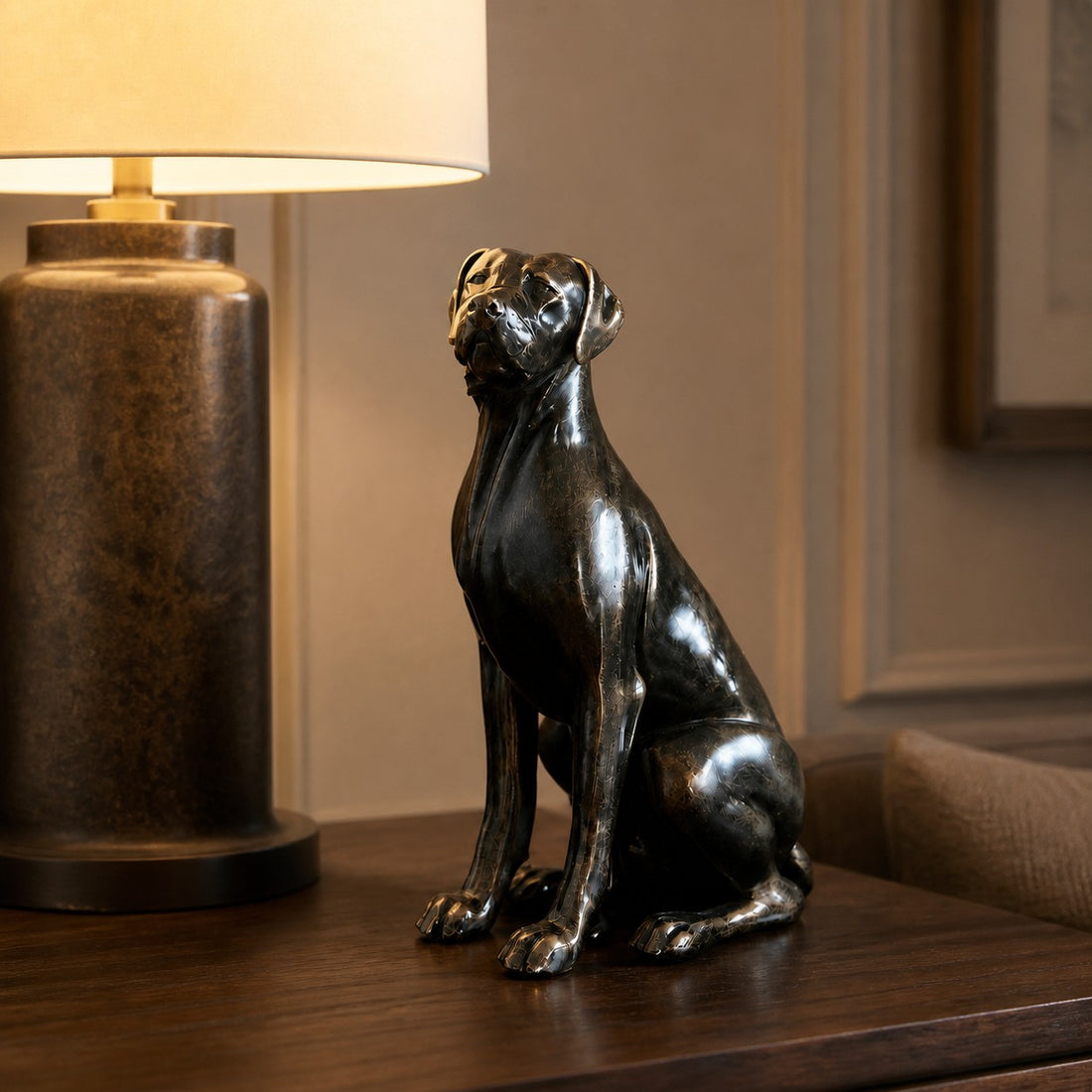 Floxo sitting dog sculpture beside a table lamp