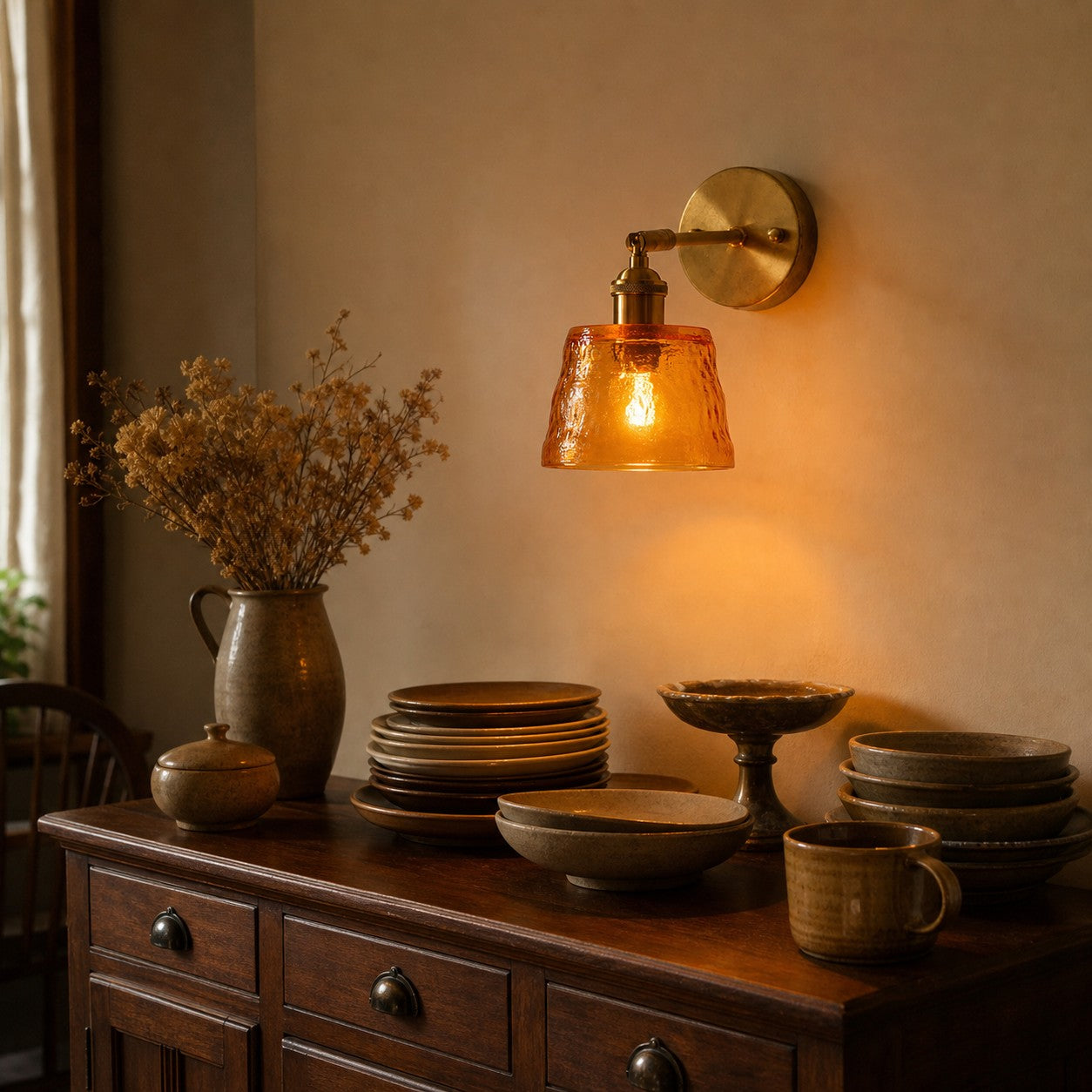 Amber brass glass wall sconce above a console