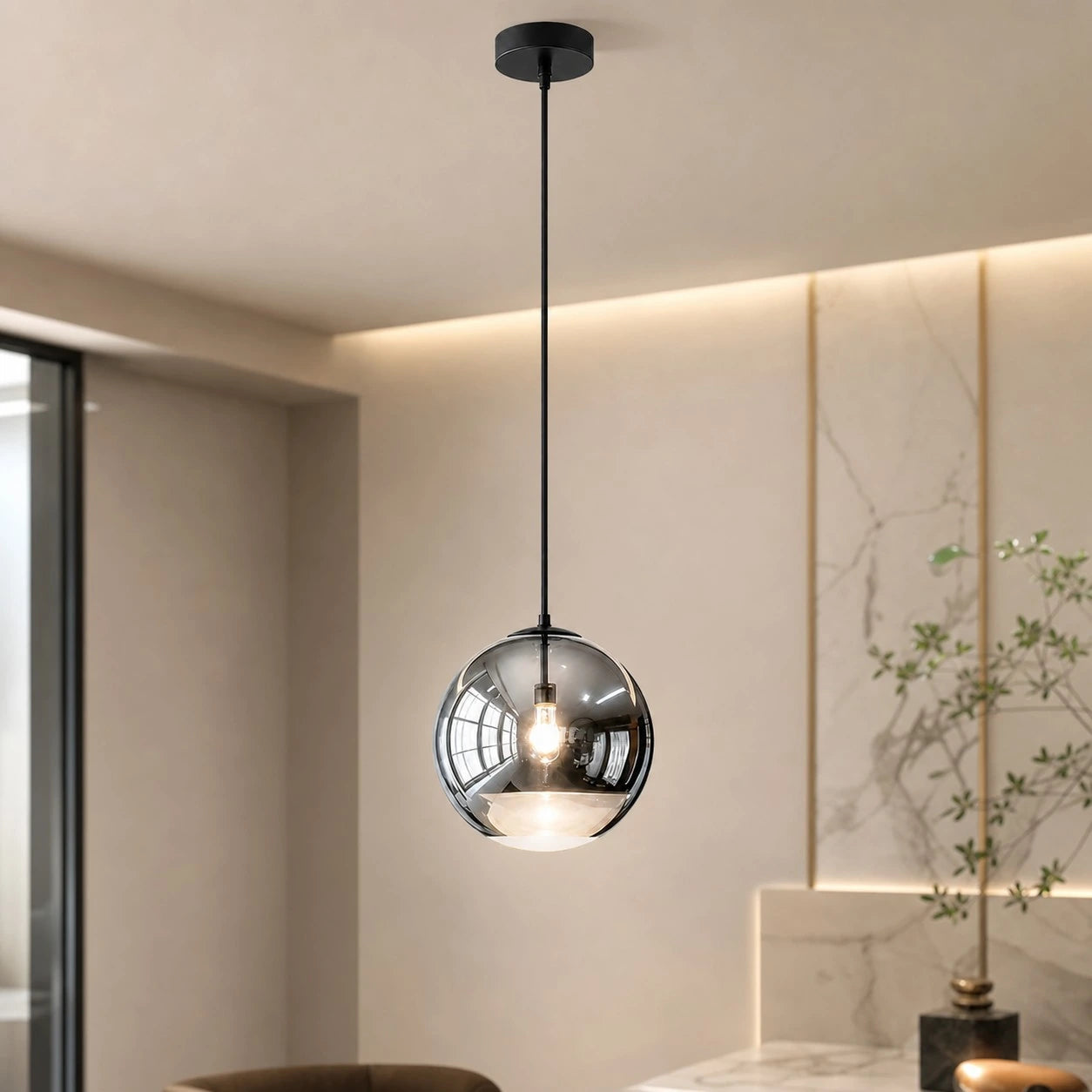 Style A Luma mirrored globe pendant in a warm modern interior