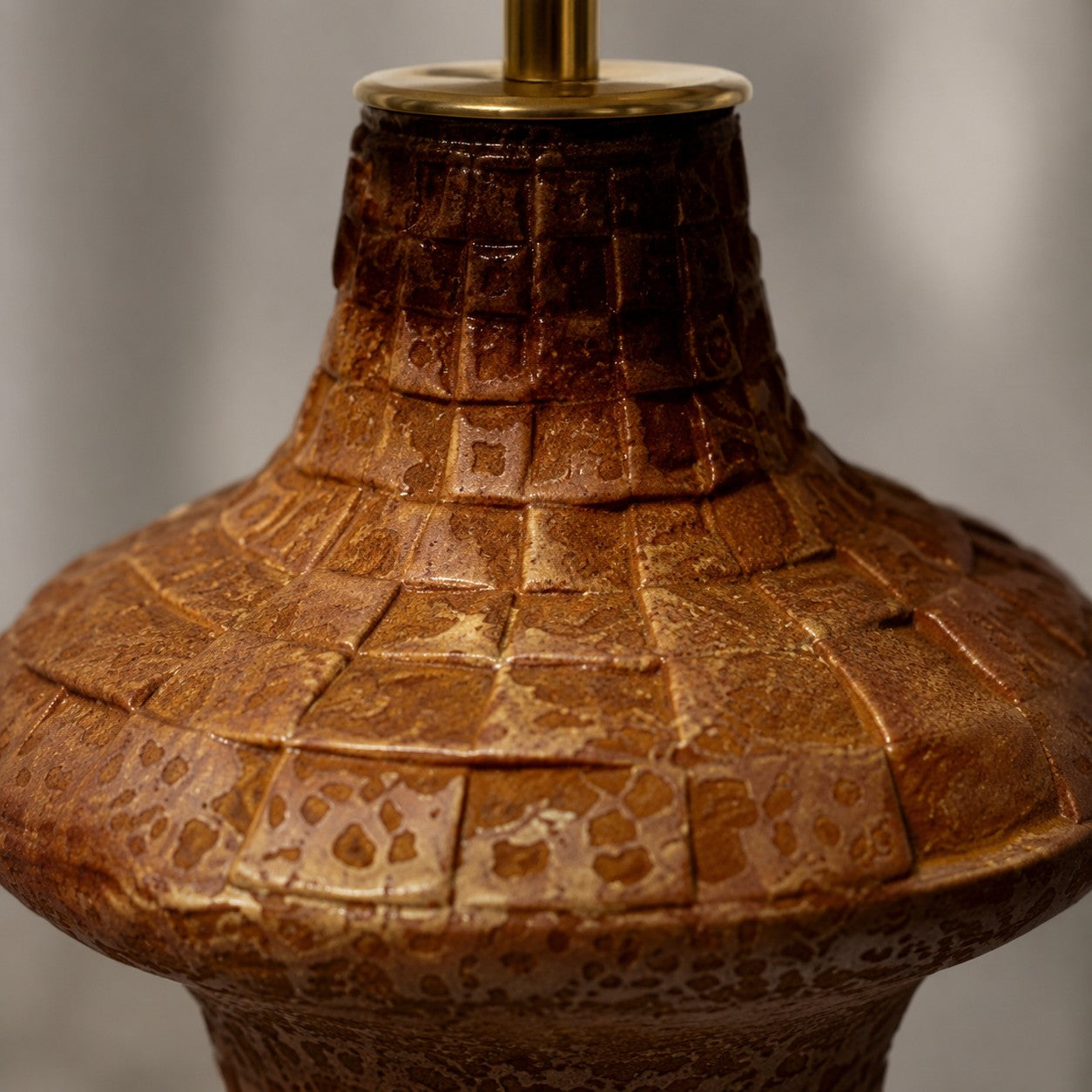 Close view of carved brown ceramic table lamp body