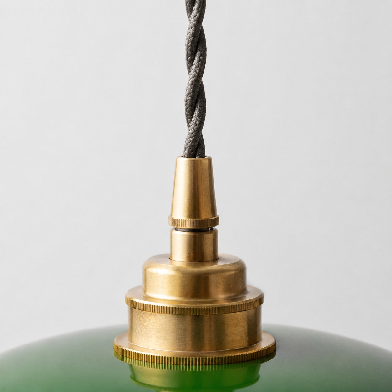 Close view of brass pendant light holder and twisted cord