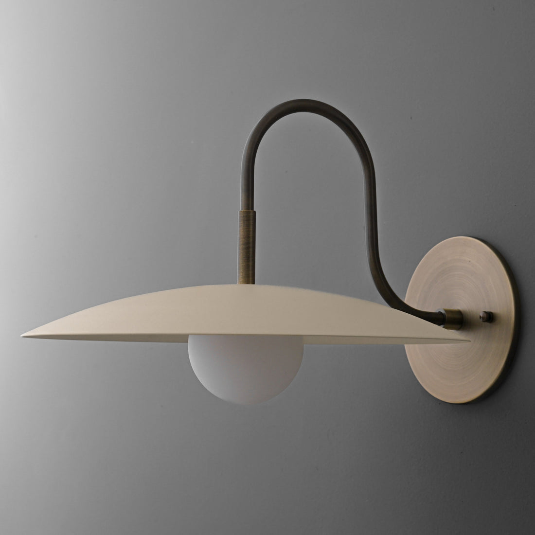 Curva Metal Modern Wall Sconce - Antique Brass Arm with Cream Disc Shade