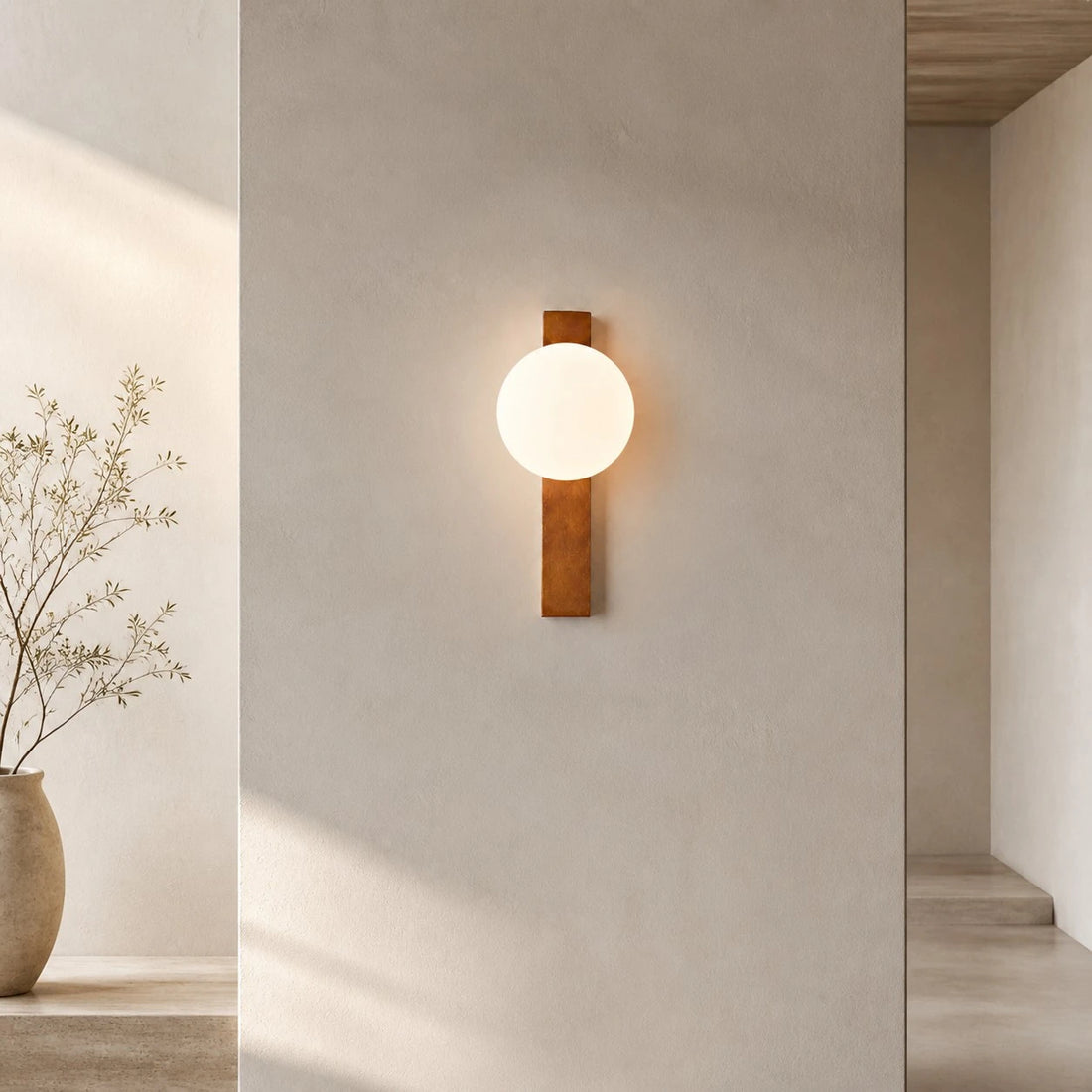 Vertical Walnut globe wall sconce in a bright hallway